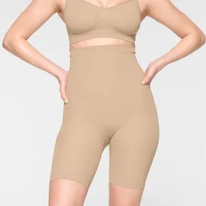SKIMS Seamless Sculpt High Waist Above The Knee Shaping Shorts In Sand Nude